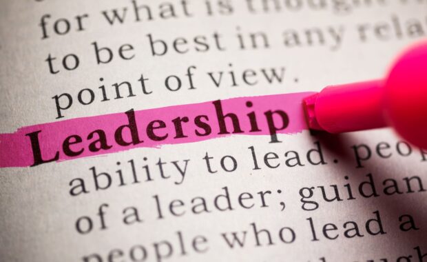 An image with a pink highlighter pen highlighting the word leadership in a book